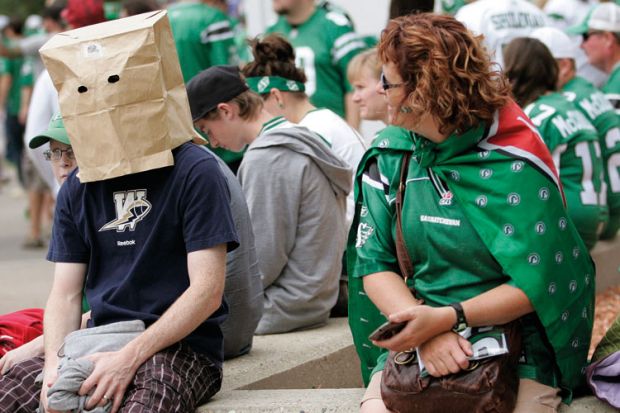Winnipeg Blue Bomber fan hides head in paper bag