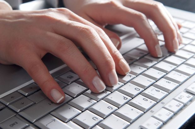 Woman's hands typing on laptop computer keyboard