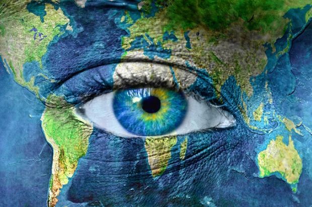 Planet earth painted around a human eye, illustrating international vision