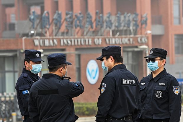 Security personnel stand guard outside the Wuhan Institute of Virology as members of the World Health Organization team investigating the origins of Covid-19 visit the institute Security personnel stand guard outside the Wuhan Institute of Virology as members of the World Health Organization team investigating the origins of Covid-19 visit the institute