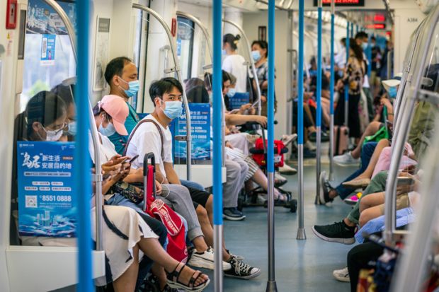 Wuhan China , 29 August 2020 Chinese people wearing surgical face masks inside the Wuhan subway carriage in Wuhan Hubei China