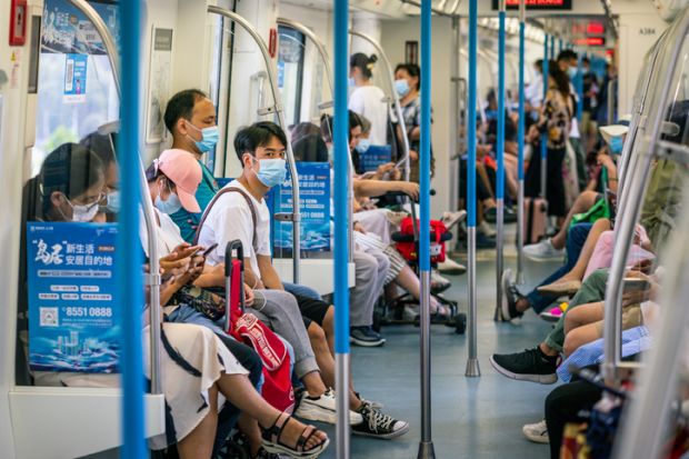 Wuhan China , 29 August 2020  Chinese people wearing surgical face masks inside the Wuhan subway carriage in Wuhan Hubei China