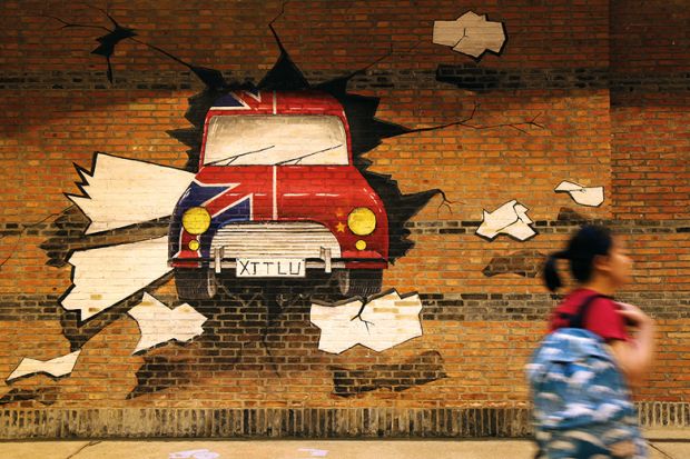 A student passes by an underpass with mural paintings at Xi'an Jiaotong Liverpool University in Suzhou, Jiangsu Province of China. Illustrates how China’s joint ventures with foreign universities could remain