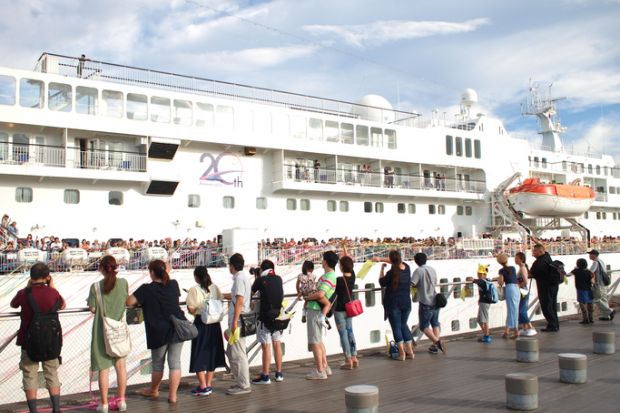 Yokohama, Japan - August 16th, 2018 People celebrating the departure of cruise ship Pacific Venus at the Osanbashi Pier in Yokohama.
