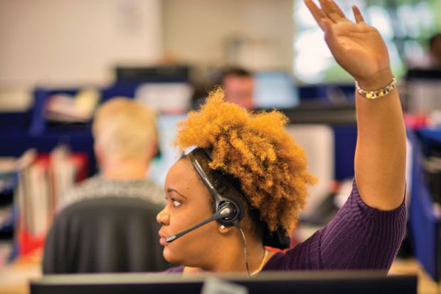 Young female student raising hand to ask question Young female student raising hand to ask question