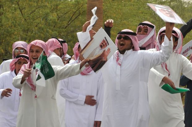 Young Saudi men cheering and celebrating