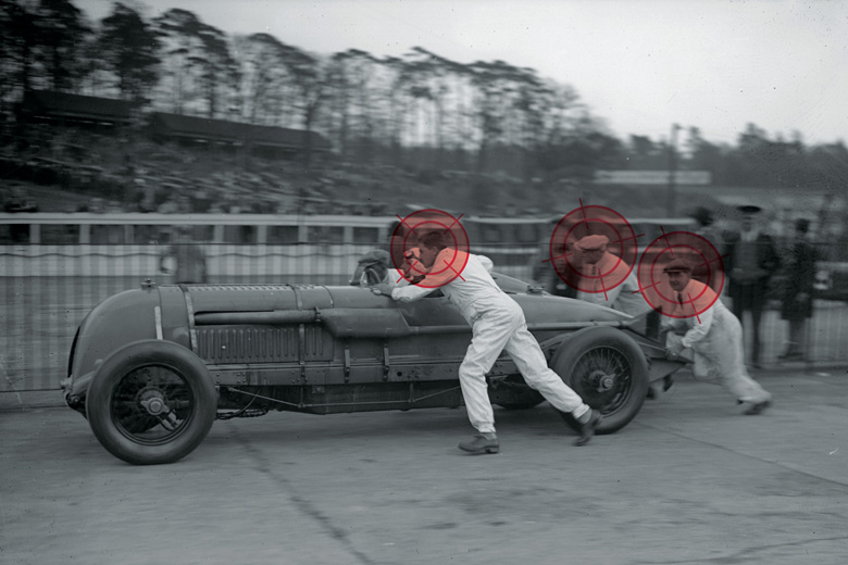 Team of men push-starting race car