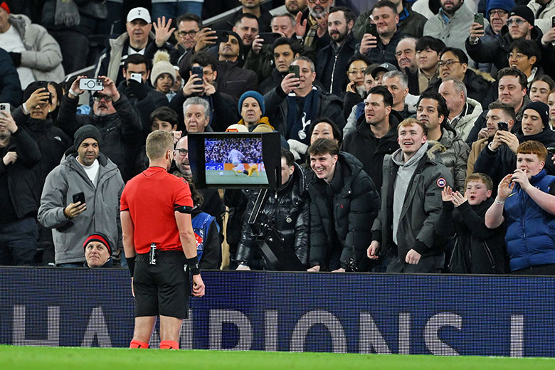 Referee Glenn Nyberg checks the VAR screen while fans of Tottenham Hotspur react during the UEFA Champions League 2025-26 League Phase MD7 match between Tottenham Hotspur and Borussia Dortmund on 20 January 2026. To illustrate the ERC review process.