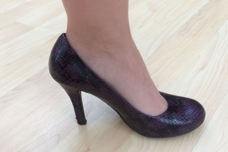 Woman's foot wearing high-heeled shoe