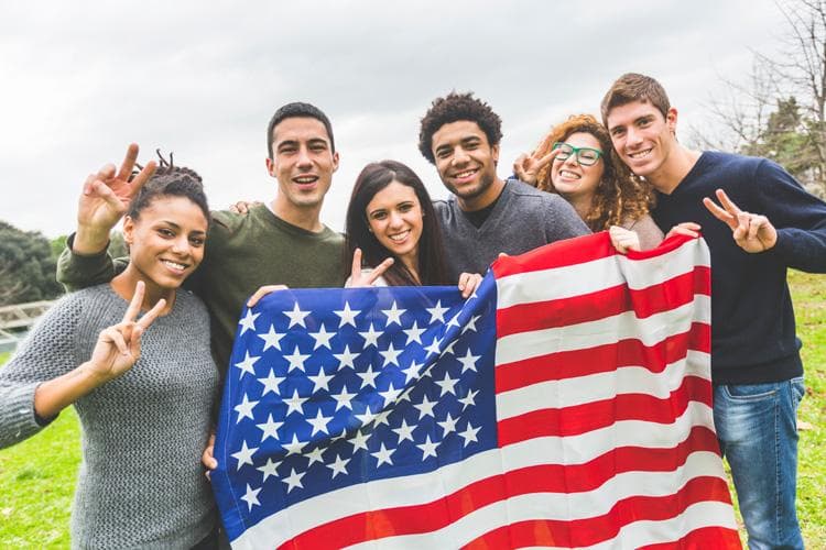 American students posing with USA stars and stripes flag