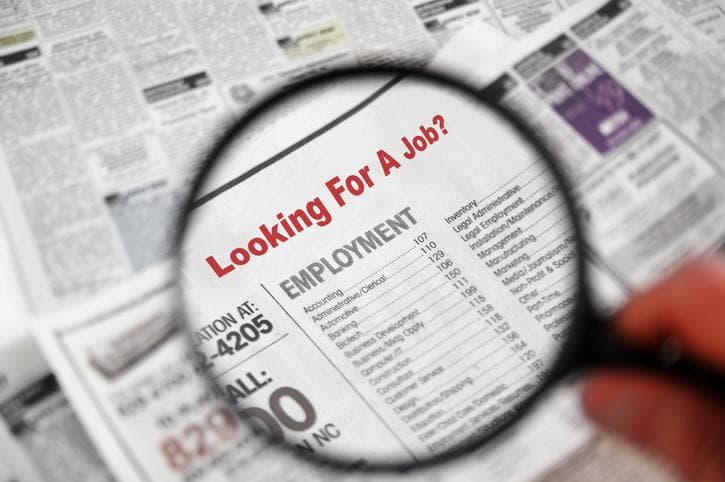 Magnifying glass searching job adverts