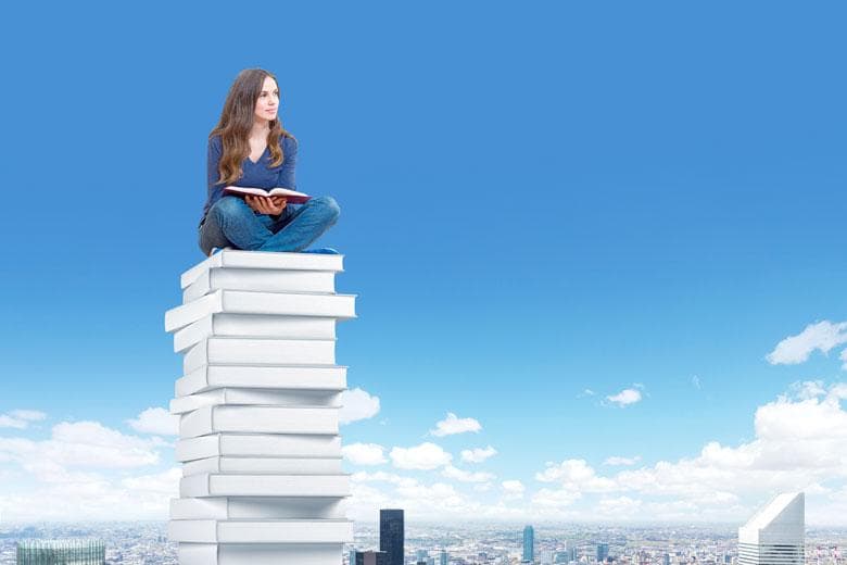 Student sitting high above city