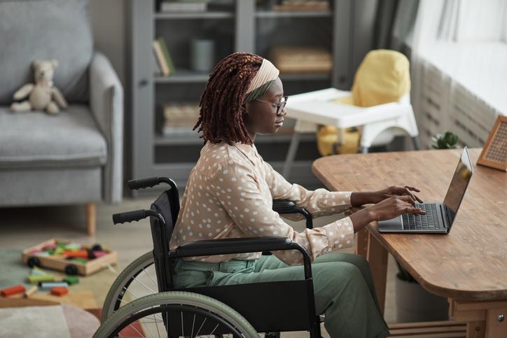 woman working on a laptop in a wheelchair