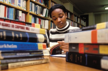 Female student reading in library