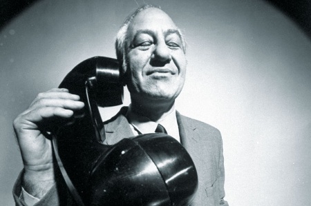 Man using huge telephone receiver