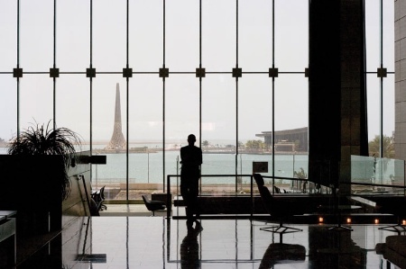 Man standing and looking out of window