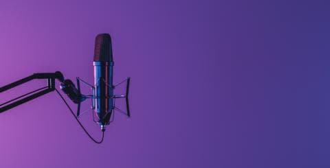 A microphone against a purple background