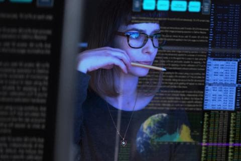 Young woman looking at data on a screen