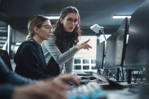 Two young women working on cybersecurity